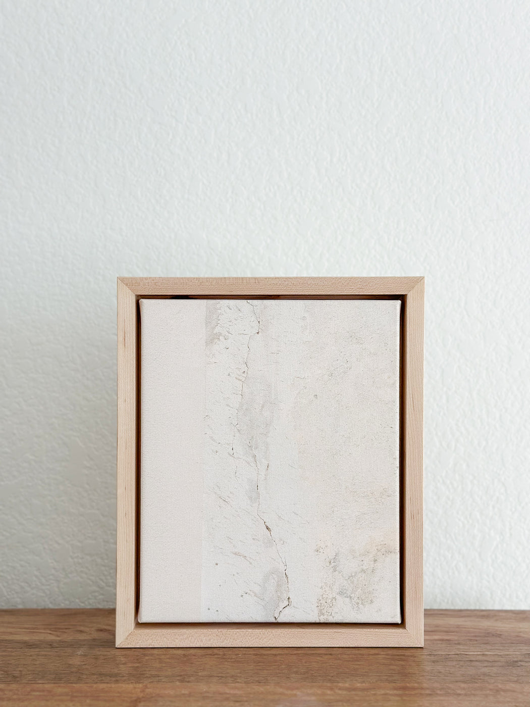 a picture frame sitting on top of a wooden table